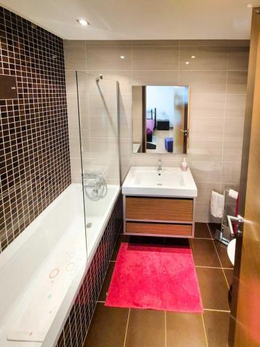 a bathroom with a tub and a sink and a shower at Água do Mar in Armação de Pêra