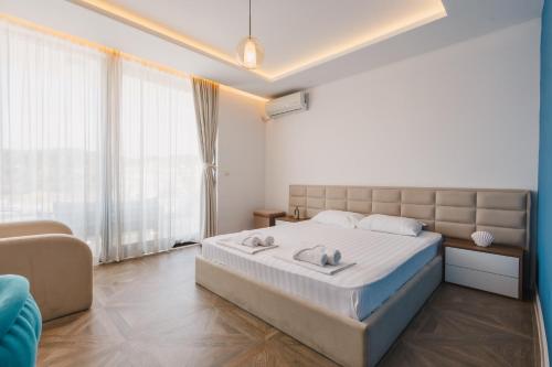 a bedroom with a large bed and a couch at Apartments Stanaj in Ulcinj