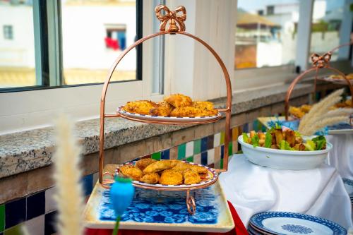 two plates of food on a table with food at Palais Zahia Hotel & Spa in Tangier