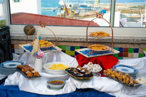 a table with several trays of food on it at Palais Zahia Hotel & Spa in Tangier
