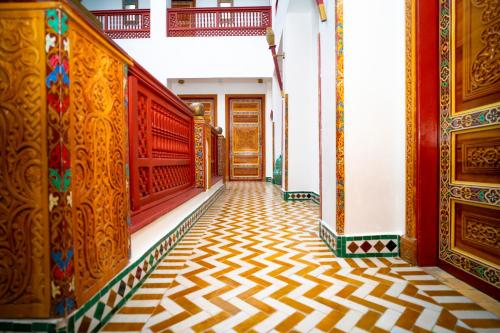 a corridor of a building with a patterned floor at Palais Zahia Hotel & Spa in Tangier