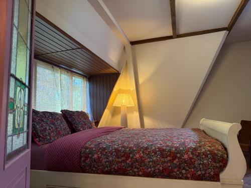 a bedroom with a bed and a window at Luxurious vintage loft near city center in Groningen