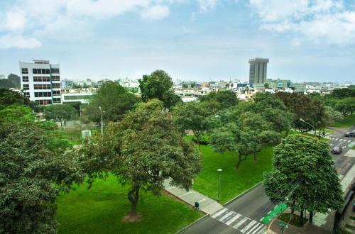 an aerial view of a city with trees and a street at Del Prado Hotel in Lima