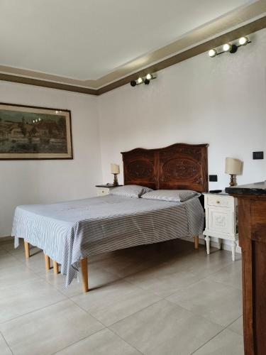 a bedroom with a large bed with a wooden headboard at Garden House in Turin