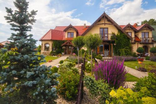 a house with a garden in front of it at Feniks Agro&Spa Adults Only in Świnoujście
