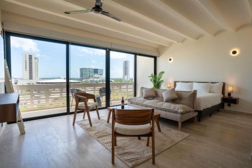 a living room with a couch and a table at Remote Work Ready Studio with Coworking and Views in Cancún