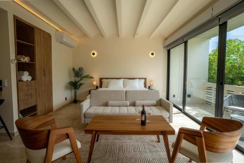 a living room with a bed and a table and chairs at Cozy Couples Spot Explore and Relax in Cancún