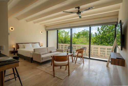 a bedroom with a bed and a table and chairs at Cozy Couples Spot Explore and Relax in Cancún