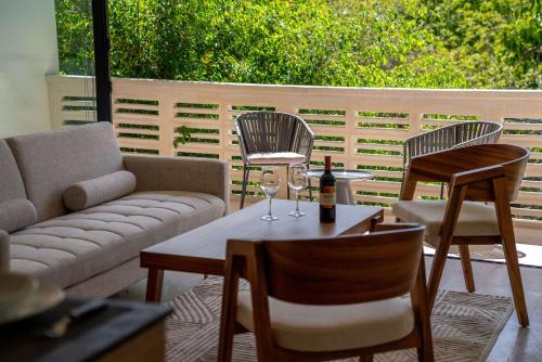 a living room with a couch and chairs and a table at Cozy Couples Spot Explore and Relax in Cancún