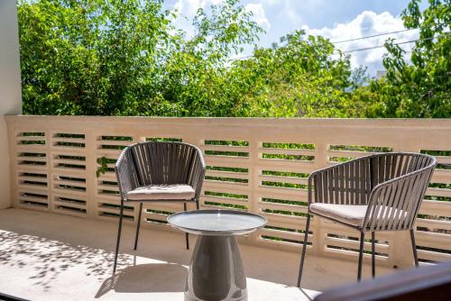 two chairs and a table on a patio at Cozy Couples Spot Explore and Relax in Cancún