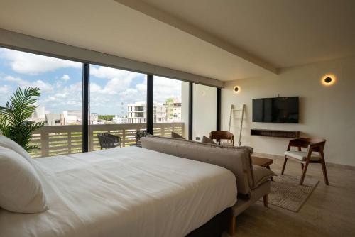 a bedroom with a white bed and a large window at Modern Confort Perfect for All Travelers in Cancún