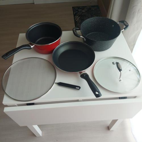 a table with two pots and pans on it at Le Chti Paradis in Méricourt