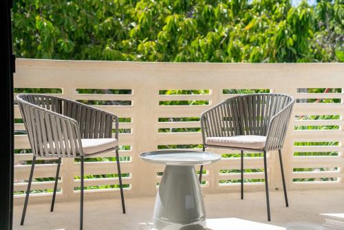 two chairs and a table on a patio at Versatile Studio Cowork Fast WiFi and Prime Location in Cancún
