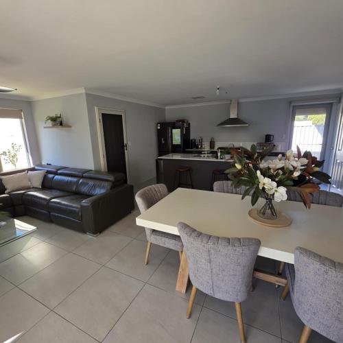 a living room with a table and a couch at Modern Bassendean Abode in Perth