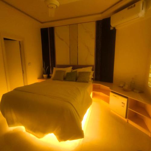 a bedroom with a bed with lights on the floor at ROYAL VILLAGE inn Dhangethi Maldives in Dhangethi
