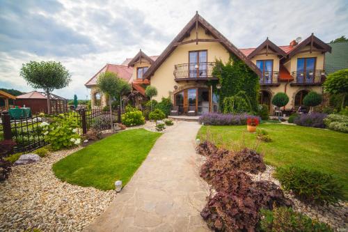a house with a walkway in front of a yard at Feniks Agro&Spa Adults Only in Świnoujście