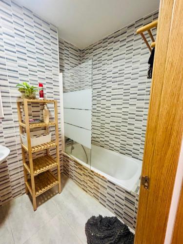 a bathroom with a shower and a tub and a sink at ROOMS Malaga Centro Jinetes in Málaga