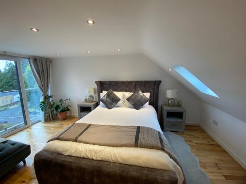 a bedroom with a large bed and a window at Modern Room in Cardiff, Wales in Cardiff