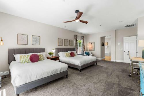 a bedroom with two beds and a ceiling fan at Mt San Jacinto View Home in Palm Springs