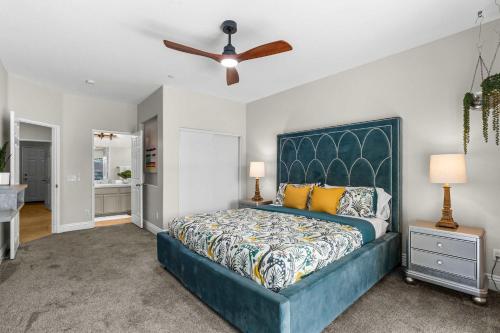 a bedroom with a blue bed and a ceiling fan at Mt San Jacinto View Home in Palm Springs