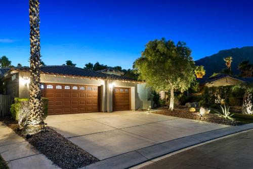 a house with a driveway and a garage at night at Mt San Jacinto View Home in Palm Springs