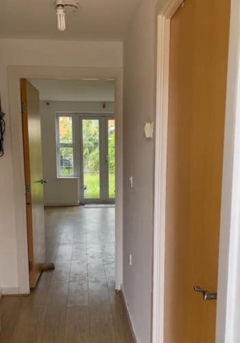 an empty hallway with a door leading into a room at Modern 3-Bedroom Home 3 Minutes from Biggin Hill Airport - Secure Gated Community in Biggin Hill