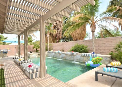 a swimming pool in a backyard with a pergola at Mt San Jacinto View Home in Palm Springs