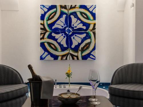 a living room with two chairs and a table with a painting at Hotel Residence in Amalfi
