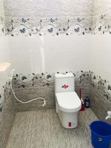 a bathroom with a white toilet in a room at Virtus home stay in Pondicherry