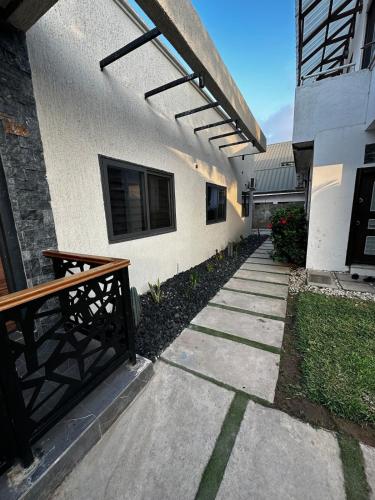 a walkway in front of a building with a bench at Bobby’s villa in Accra