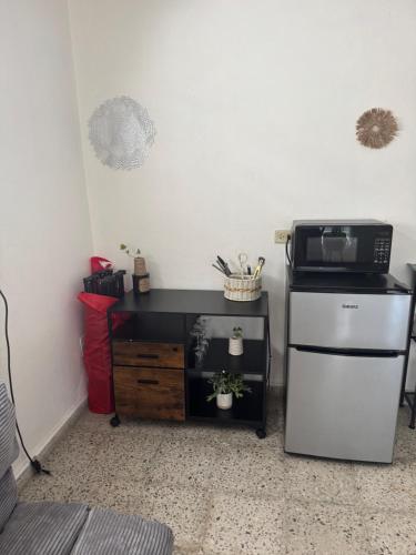a kitchen with a refrigerator and a microwave at Escape to Calm Quiet Bliss in Humacao