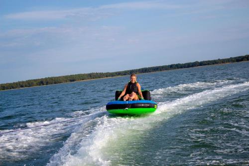 a person riding on a raft on the water at Hundi Holiday Home Main House in Hiiumaa