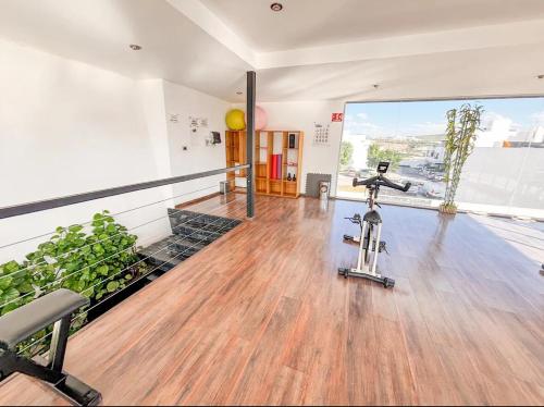 an empty room with a gym with a exercise bike at A haven of peace and comfort with a pool in Hércules