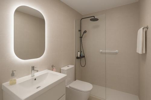 a bathroom with a toilet and a sink and a shower at Villa RIHIVELI in Mogán