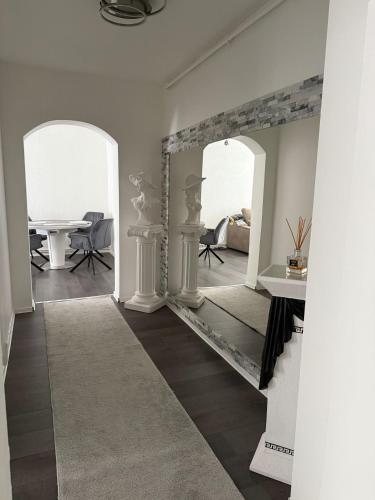 a living room with a mirror and a table at Apartament Alex in Mediaş