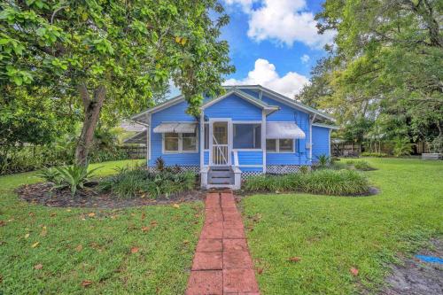 a blue house in a yard with a grass at Blue Reverie - Downtown Cottage in Fort Lauderdale