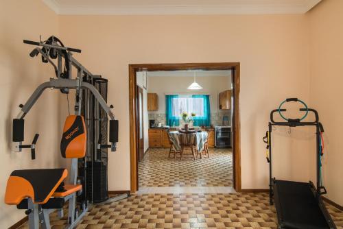 a room with a gym with a table and a dining room at Sirens House in Tavronitis