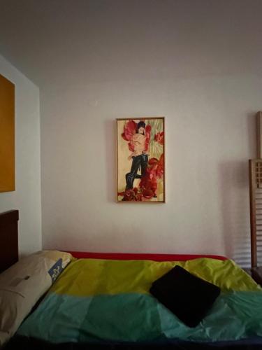 a bedroom with a painting hanging on the wall at Villatopol in Rząska