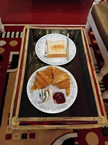 a table with two plates of food on top at L'EDELWEISS Heritage House in Puducherry