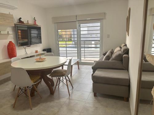 una sala de estar con una mesa y un sofá en Departamento Castello -Viedma, en Viedma