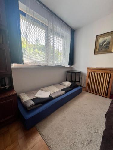a bed sitting in a room with a window at Villatopol in Rząska