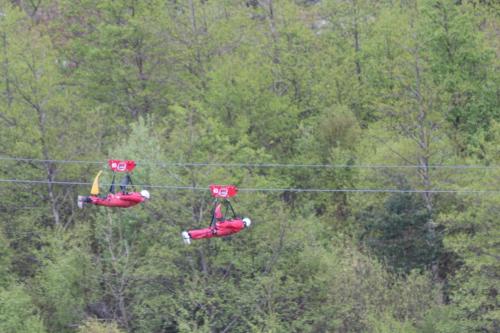 two people are riding on a zip line at The Old School House Bed and Breakfast in Llanbrynmair
