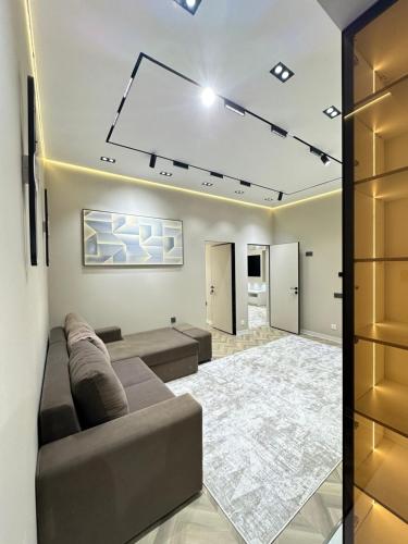 a living room with a couch and a rug at Luxury Apartment in City Center in Dushanbe