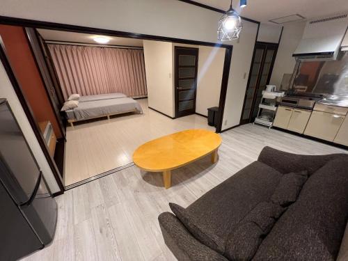 a living room with a couch and a table at Konyamachi2F しげの里 in Takamatsu