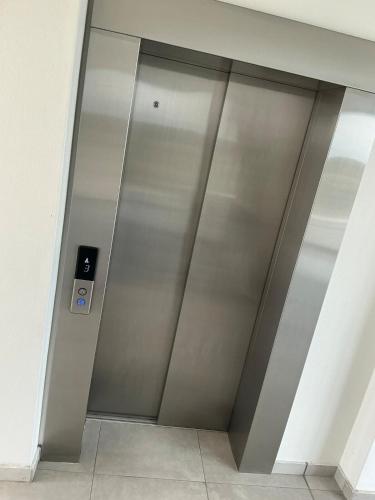 a metal elevator door in a building at DRJ Luxe Table view in Table View