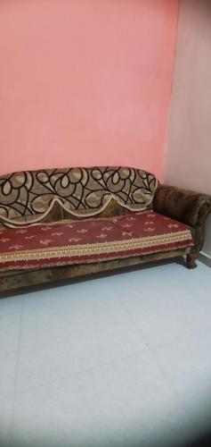 a bench sitting in a room next to a wall at Motimani in Ahmedabad