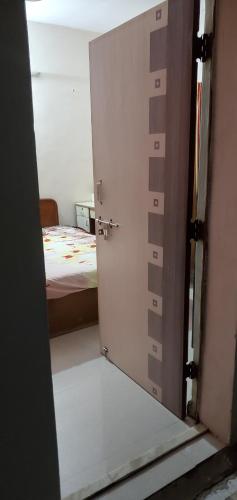 an open door to a bedroom with a bed at Motimani in Ahmedabad