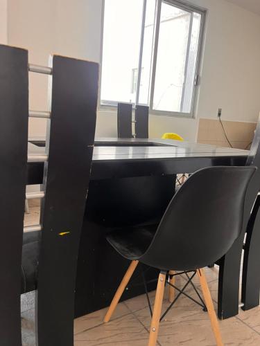 an office with a black desk and a black chair at La Casa de las Aguas in Ixmiquilpan