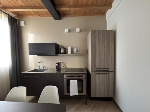 a small kitchen with a sink and a refrigerator at Appartamenti Saragozza a due passi da Piazza Grande - WIFI e parcheggio gratuito in Modena