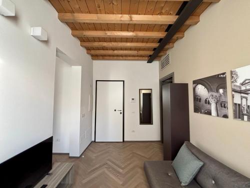 a living room with a couch and a wooden ceiling at Appartamenti Saragozza a due passi da Piazza Grande - WIFI e parcheggio gratuito in Modena
